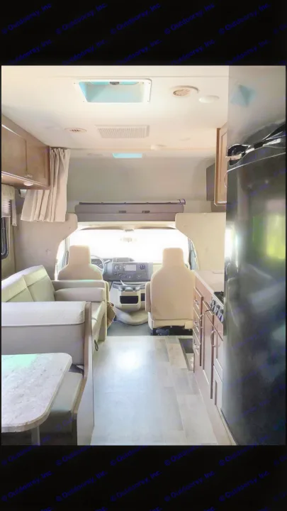 Spacious RV rental interior featuring a full kitchen, comfortable living area, and driver's cab.. Winnebago Outlook 2019