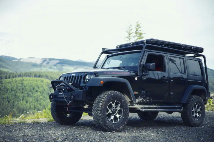 This black Jeep Wrangler, with a roof-top tent, is ready for your rugged rv rental adventure.. Jeep Wrangler Unlimited Rubicon 4x4 2013
