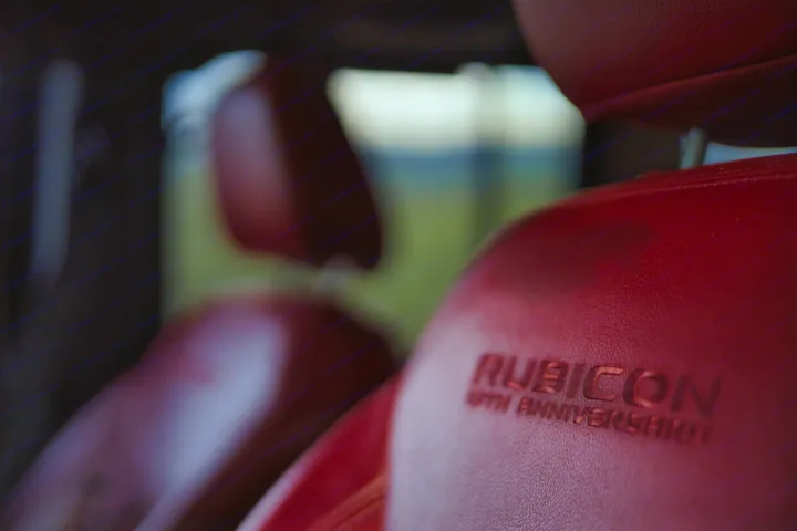 Comfortable red leather seats inside a vehicle with 'RUBICON 19TH ANNIVERSARY' branding. Ideal for road trips or complementing your RV rental.. Jeep Wrangler Unlimited Rubicon 4x4 2013