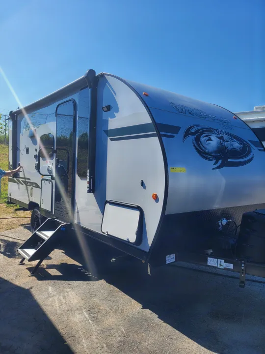 This sleek gray Wolf Pup travel trailer, perfect for an RV rental, features convenient entry steps and an awning.. Forest River Cherokee Wolf Pup 16PFBL 2021