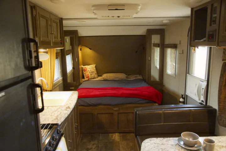 Functional RV rental interior with compact kitchen, cozy bedroom, and dining area. Enjoy home-like comfort on the road.. Other Passport 2019