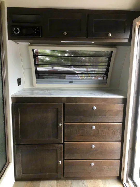 RV rental: Modern RV interior with dark wood cabinetry, a media system, ample storage, and bright countertop.. T@B T@B 320 OffRoad 2020