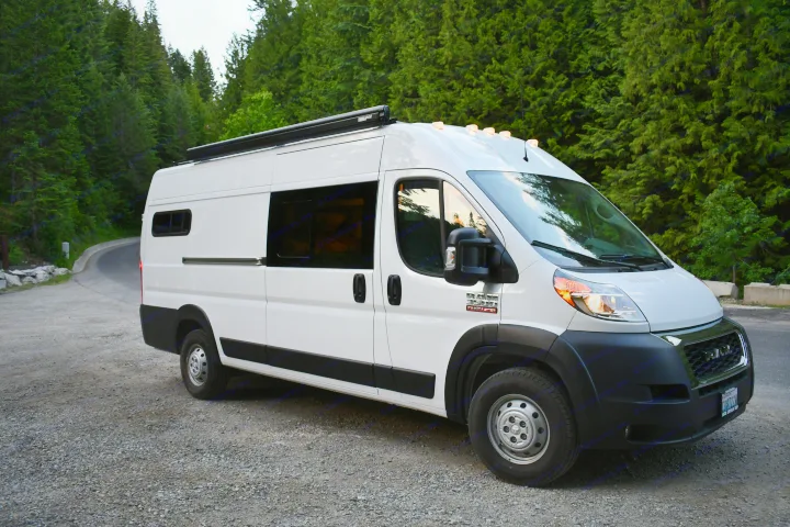 This white Ram ProMaster camper van with an awning is ready for your next rv rental journey in nature.. Other Other 2021