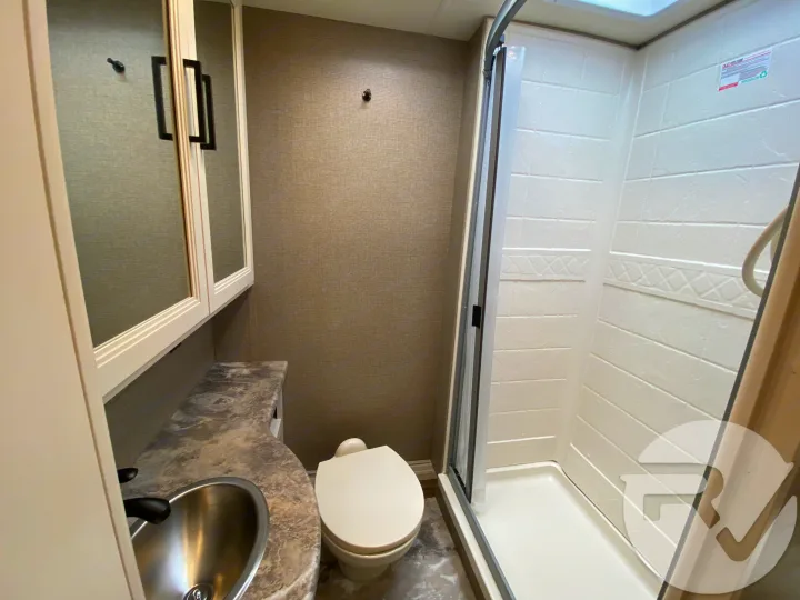 This RV rental bathroom features a compact toilet, sink vanity, and a refreshing walk-in shower, maximizing comfort on the go.. Thor Motor Coach Four Winds 2021