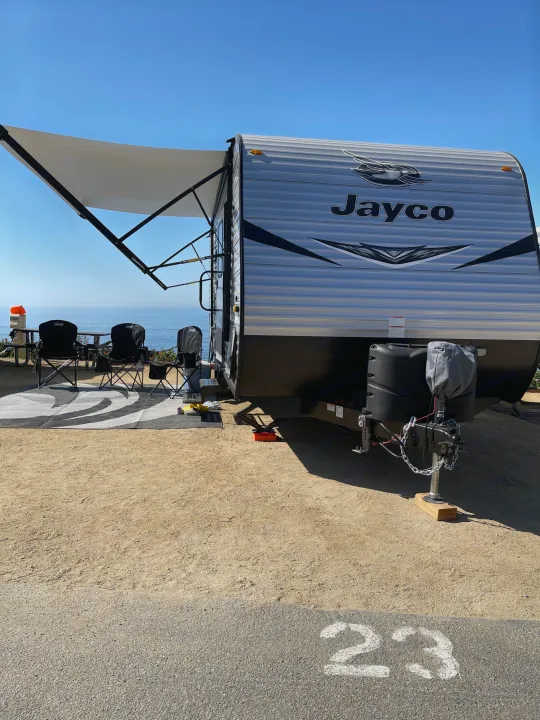Jayco rv rental at oceanfront campsite 23. Awning extended, chairs ready for a scenic view.. Jayco Jayflight 224bhw 2021