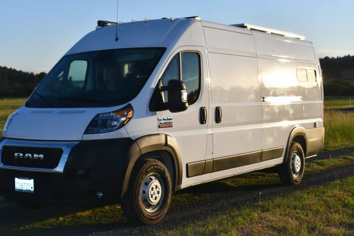 White Ram Promaster van, converted into an RV rental, shines in golden light, ready for camping & exploration.. Other Other 2021