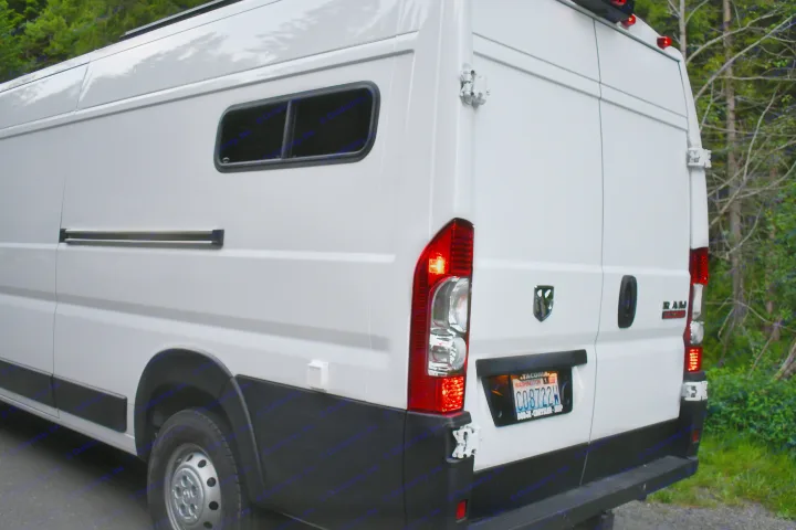 Rear view of a white Ram ProMaster camper van, possibly an RV rental, with a side window & Washington license plate.. Other Other 2021