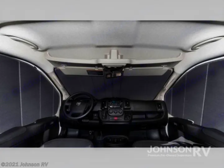 RV rental interior: Front cab with dashboard, steering wheel, and window shades for privacy. Perfect for a road trip!. Winnebago Solis 2022