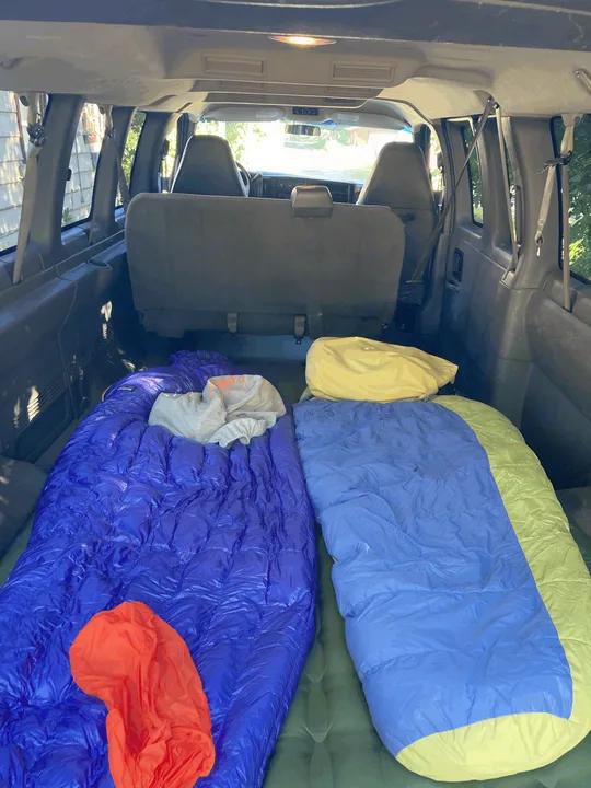 Inside this RV rental, two sleeping bags and air mattresses create a cozy setup for your next camping road trip.. Chevrolet Express 2007