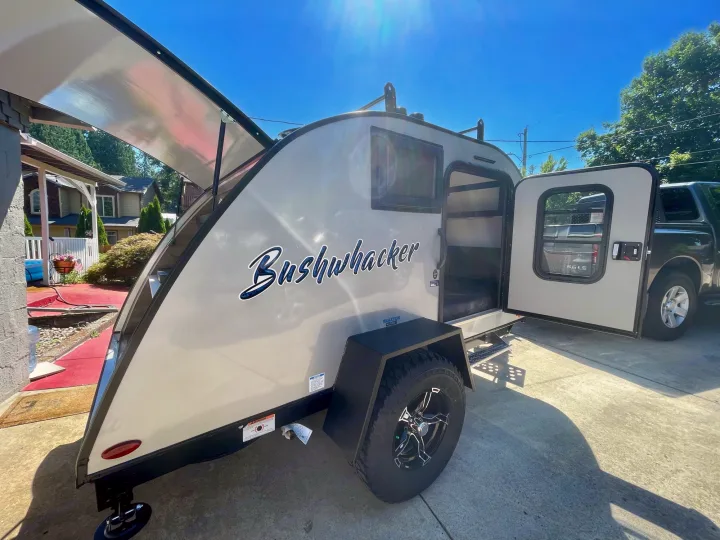 Bushwhacker teardrop travel trailer, ideal for an rv rental adventure. Sunny day, awning extended.. Braxton Creek Bushwhacker 2021