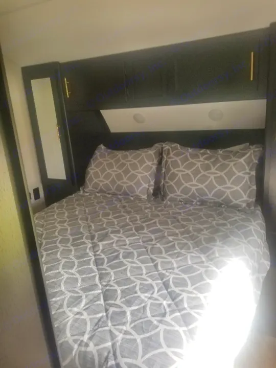 Queen bed with 2 closets , phone charger and end tables ` storage under bed. Forest River Cherokee Grey Wolf Black Label Toy Hauler 2021