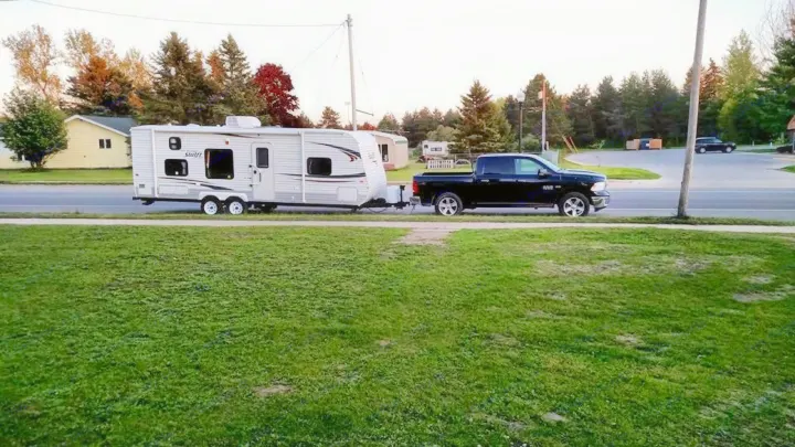 Black pickup truck with an RV rental travel trailer (Swift) parked roadside, ready for your next adventure.. Jayco Jay Flight Swift 2012
