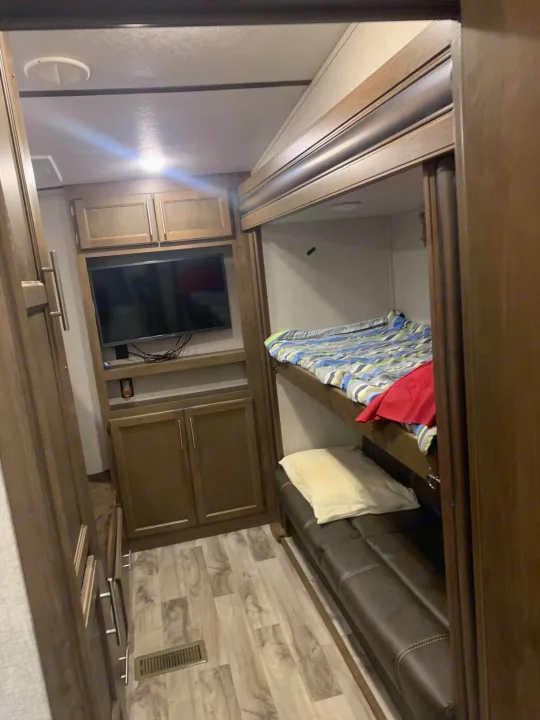 Bunkroom with 2 sets of bunks and a TV.. Keystone Cougar Half-Ton 2019