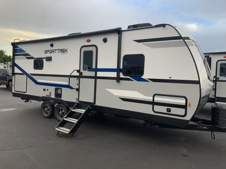 A sleek white & gray SportTrek travel trailer camper, an ideal rv rental for your next outdoor adventure or road trip.. Venture Rv Sporttrek 2022