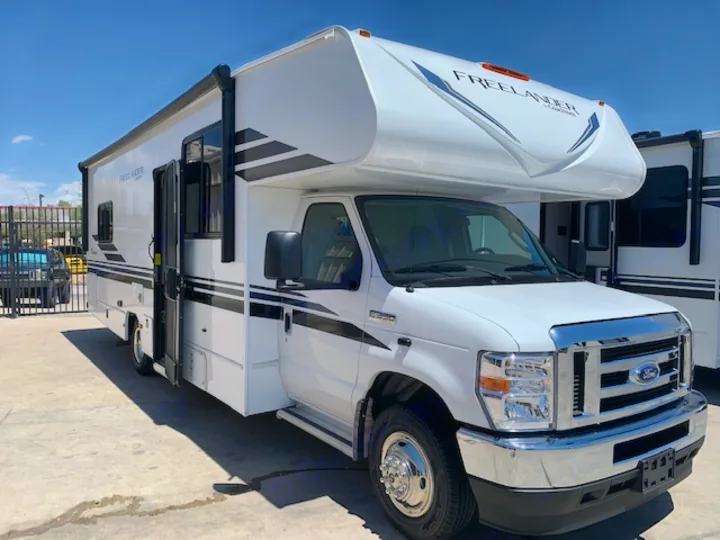 A sleek white Ford Class C RV, a "FREELANDER by Coachmen" motorhome, perfect for rv rental trips.. Coachmen Freelander 2021
