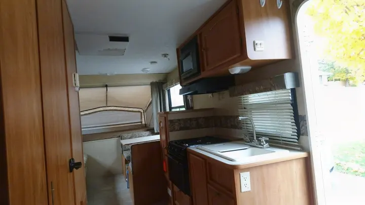 Spacious rv rental interior showing kitchen, dinette, and pop-out bed area.. Starcraft Travel Star 2007