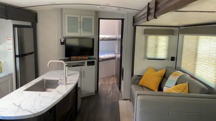 Modern RV rental interior with full kitchen, cozy living space, and bunk beds for your next adventure.. Keystone RV Bullet Ultra Lite 2021