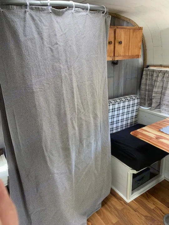 RV rental: Compact interior with a grey bed, wooden table, and clever storage. Ideal for travel comfort.. Nomad Rear fold 1962