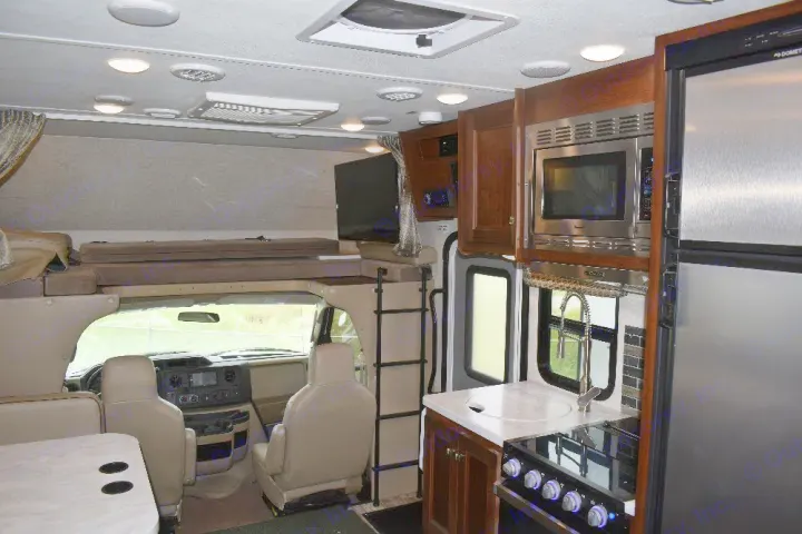 Spacious RV rental: fully equipped kitchen, comfy over-cab bunk, and inviting living space. Ready for adventure!. Forest River Sunseeker 2019