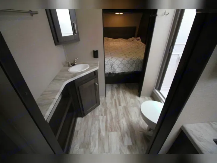 RV rental: Compact interior with a bedroom, vanity, sink, and toilet/shower area visible.. Grand Design Transcend Xplor 2021