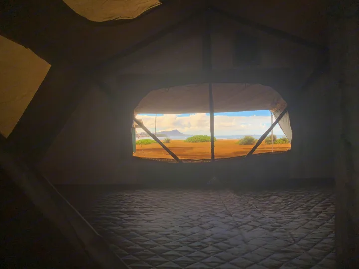 Inside an RV rental's rooftop tent, a cozy quilted mattress awaits with a stunning view of Hawaii's Diamond Head.. Toyota Tacoma 2009