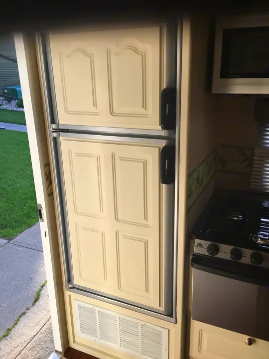 RV rental kitchen: Features a cream refrigerator, Dometic microwave, and gas stove, ready for your travels.. Max Lite ML26RK 2006