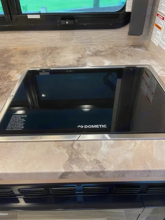 RV rental kitchen: Dometic microwave, window, and marbled counter. Compact & functional for travel.. Thor Gemini 2021