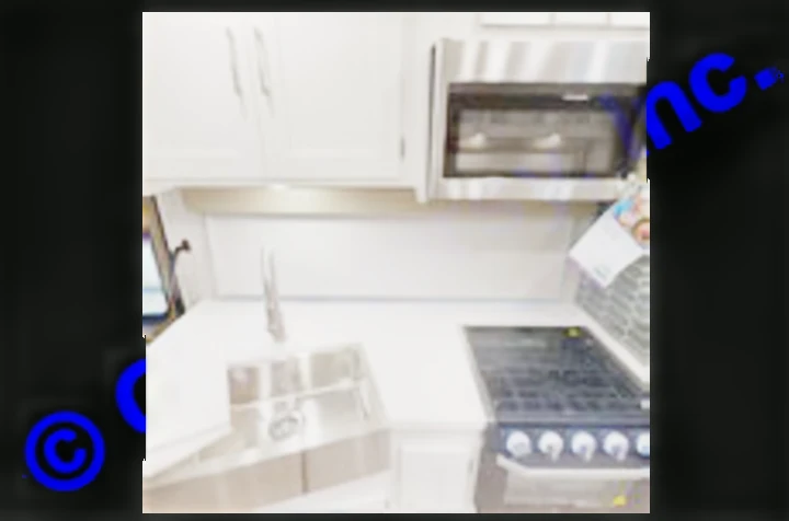 This RV rental kitchen features white countertops, a stainless sink, gas stove, and microwave—perfect for your next adventure.. Coachmen Mirada A-Class 2022