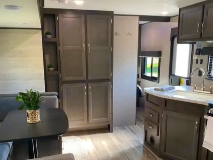 Spacious RV rental interior featuring a modern kitchen, dining area, and ample cabinet storage.. Jayco Jay Flight SLX 2021