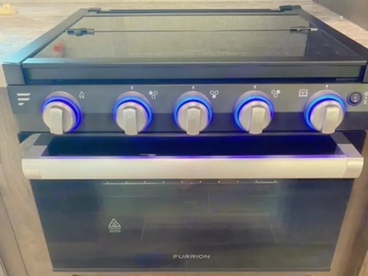 Enjoy home cooking in your RV rental with this sleek, blue-lit Furrion oven and stovetop.. Jayco Jay Flight SLX 2021