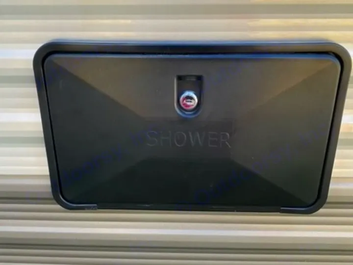 External shower port on an RV rental. Black cover with lock for outdoor rinsing, common RV utility.. Jayco Jay Flight SLX 2021