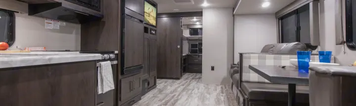Spacious RV rental interior featuring a modern kitchen, comfortable dinette, and bunk beds, ideal for family travel.. Grand Design Other 2021