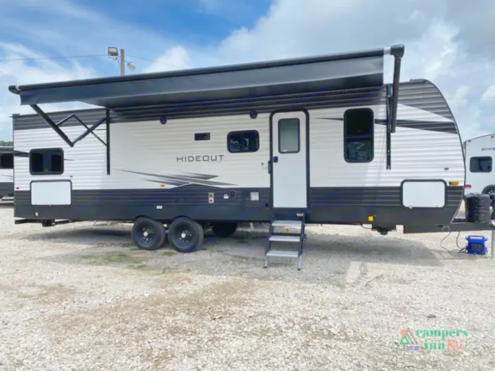 White & black Hideout travel trailer RV with extended awning, available for rv rental.. Keystone Hideout 2021