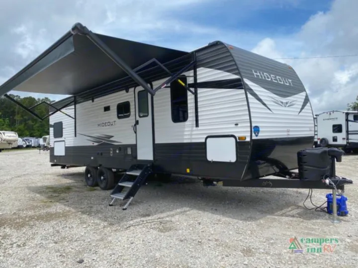 Spacious Hideout travel trailer, with awning extended, perfect for your next RV rental or camping trip.. Keystone Hideout 2021