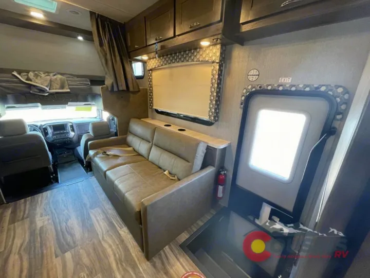 RV rental interior showing cockpit, sofa seating, overhead bunk, and main entry door.. Nexus Rebel 2022