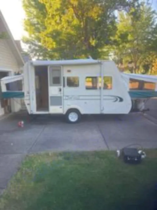 Shows left side entrance with both front and back fold downs open.. R-Vision Trail-Lite 1999