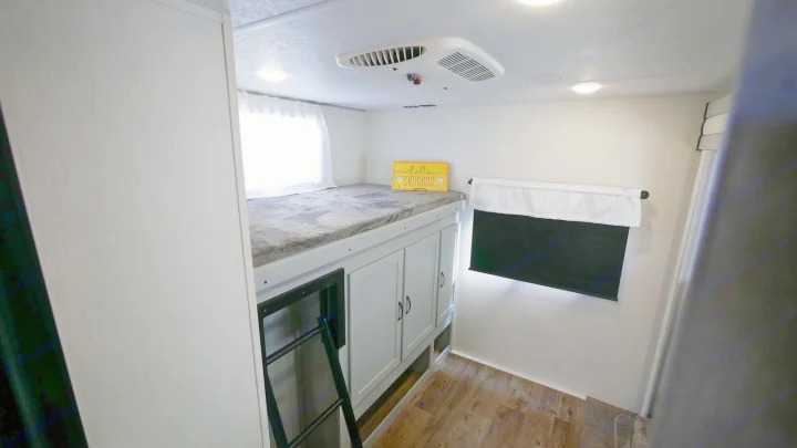 RV rental: View of a bright bunk room with an upper bed, ladder, storage cabinets, window, and AC unit.. Forest River Vibe 2021