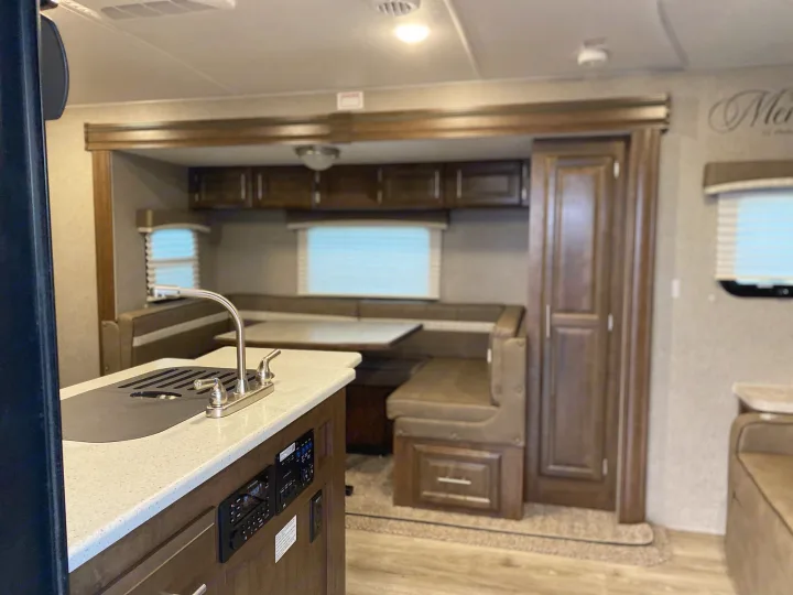 RV rental: modern kitchen with sink, spacious dinette area with bench seating. Clean interior for your travels.. Flagstaff Micro Lite 2021