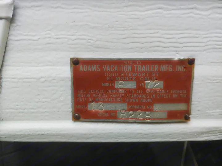An RV manufacturer's identification plate for an Adams Vacation Trailer. Details June 1972 build, Model 3; useful for RV rental history.. Adams Cardinal Travel Trailer 1972