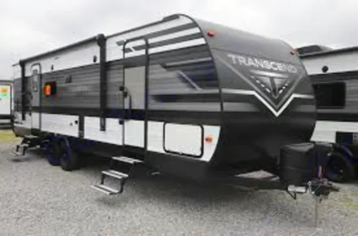 A large, modern black and white travel trailer RV, ideal for an RV rental adventure.. Grand Design Other 2021
