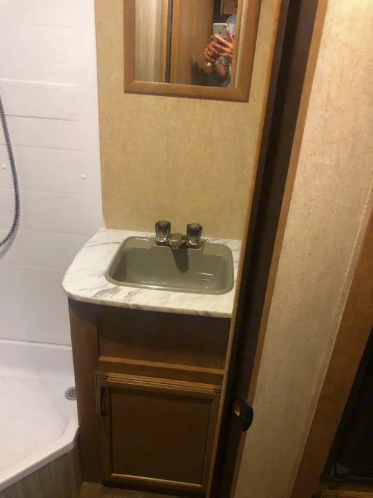 RV rental bathroom showing a compact vanity with a gray sink and marble-look counter, next to a white shower.. Starcraft Launch 2018
