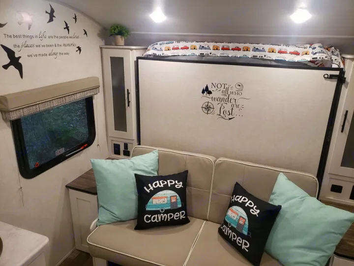 Cozy RV rental interior with comfy seating, bunk bed, inspiring decor, and scenic window views for your next adventure.. Forest River R-Pod 2022