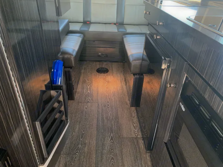 RV rental: Modern campervan interior with dark wood-look floors, comfy bench seating, and galley kitchen.. Roadtrek Agile Ss 2019