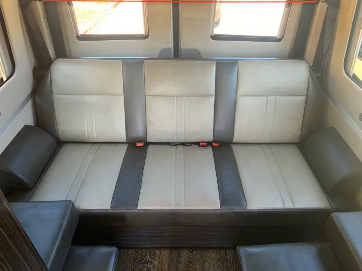 Spacious RV rental interior featuring comfortable two-tone bench seating with seatbelts, perfect for travel.. Roadtrek Agile Ss 2019
