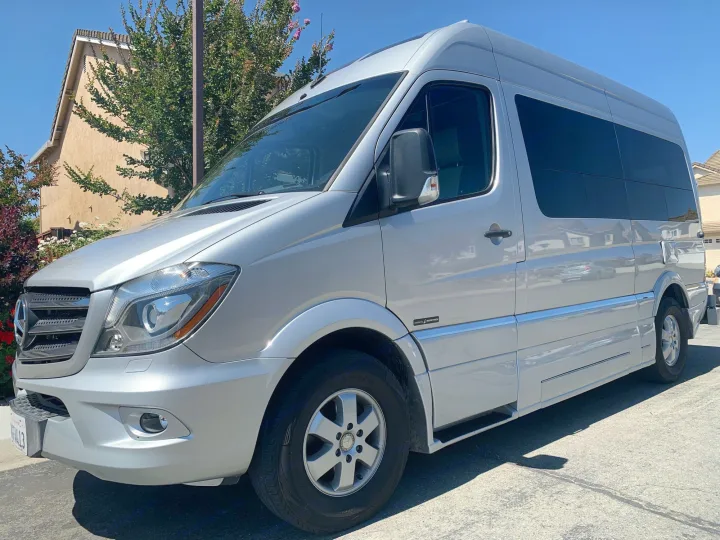 A silver Mercedes-Benz Sprinter van parked outdoors, available as an rv rental.. Roadtrek Agile Ss 2019