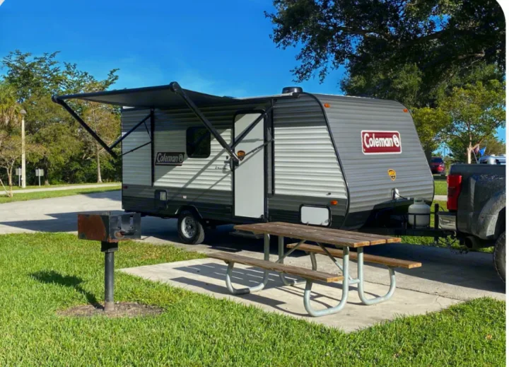 Sunny RV rental: Coleman travel trailer with awning, picnic table & grill at a spacious campsite.. Coleman COLEMAN LANTERN 2021