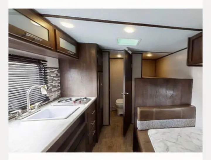 RV rental interior: well-equipped kitchenette, dinette, & hallway to bathroom/bunk beds for spacious travel.. Coleman COLEMAN LANTERN 2021