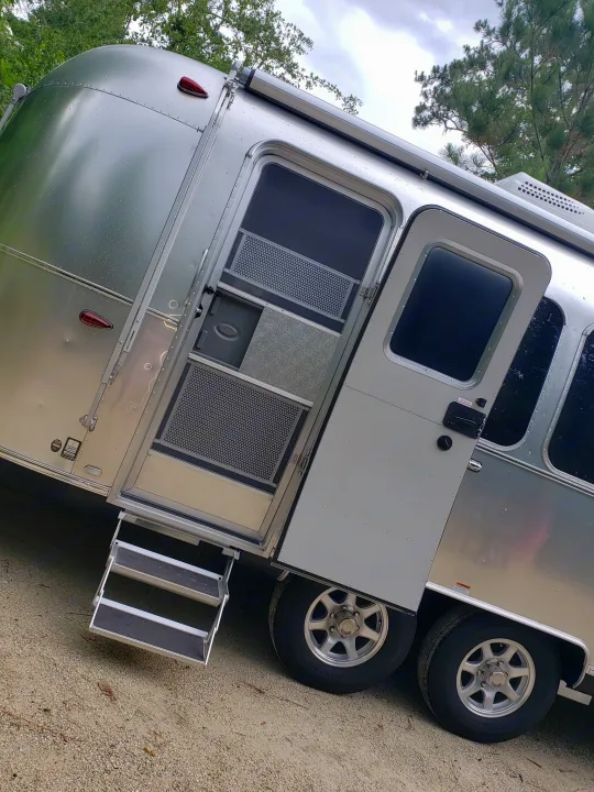Shiny silver Airstream RV rental with door open & steps down, ready for your next adventure.. Airstream Flying Cloud 2020