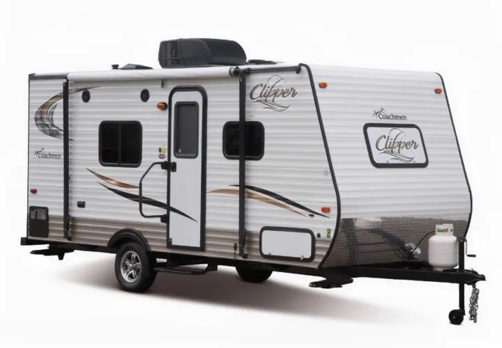 A modern white and brown Coachmen Clipper travel trailer, an ideal RV rental for camping trips, with rooftop AC and awning.. Coachmen Clipper 2016