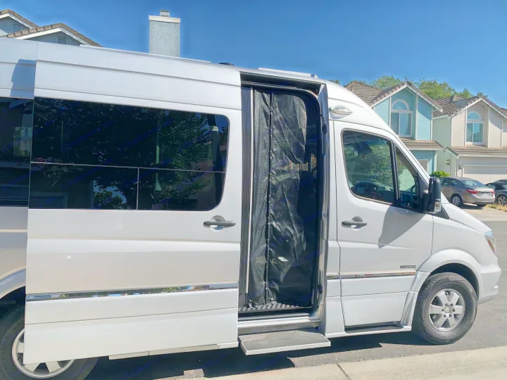Silver RV van with open sliding door, mesh screen, and retractable step. Perfect for your next RV rental road trip.. Roadtrek Agile Ss 2019